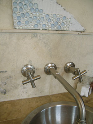 Glass nuggets can look like a sea of bubbles or a glistening pavé of gemstones. The nuggets at right were set with the rounded tops down into the mastic for a pebbly effect. Those above have the rounded side facing out and appear to be bubbling right out of the wall.